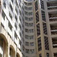 Tall building looking upward with many windows